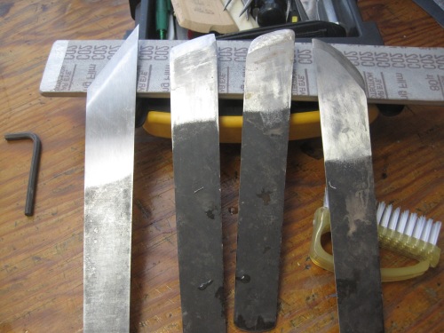 From left to right: a Hewit paring knife I use as a blank; two right-handed lifting knives after being sharpened on a Peachey slab of 80-micron sandpaper, left-handed knife after same. 