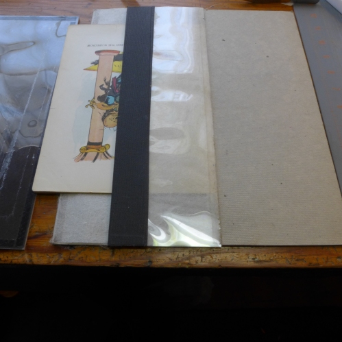 Step three: lift the buckram flap, and fold the whole flap over the folio or signature, thus bringing the otherwise wiggly half of the pasted repair tissue cleanly over the fold